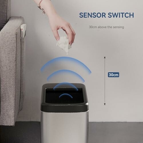 Hand hovering over sensor trash can with wave signals.