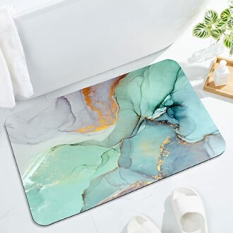 Aqua marble bathroom mat with abstract design on a bathroom floor.