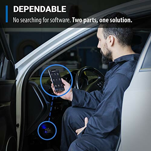 Man using diagnostic device in car with smartphone app.