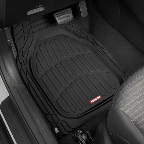 Black car floor mat in driver's side footwell.