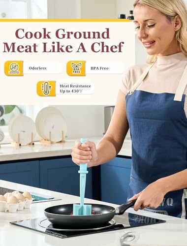 Person cooking ground meat with utensil in kitchen.
