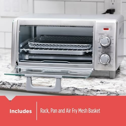 Countertop toaster oven with rack, pan, and air fry mesh basket.