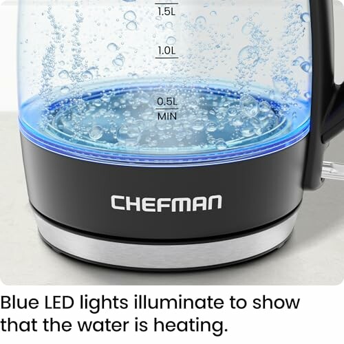 Electric kettle with blue LED lights indicating heating.