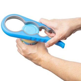Person using a blue jar opener tool on a bottle lid