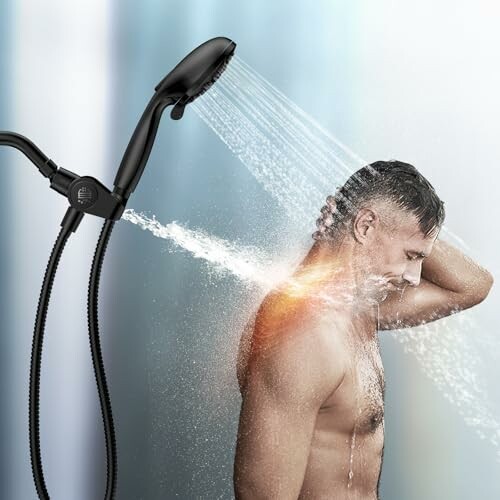 Man showering with a handheld showerhead.