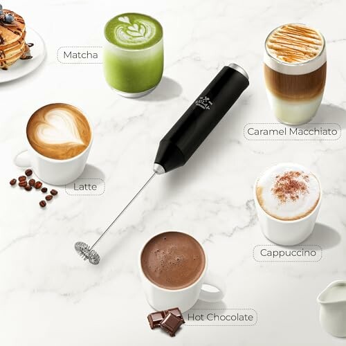 Milk frother surrounded by cups of matcha, caramel macchiato, latte, cappuccino, and hot chocolate on a marble surface.