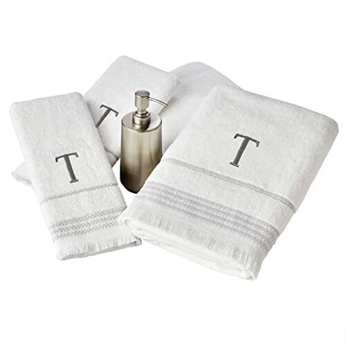 Monogrammed towel set with a dispenser.
