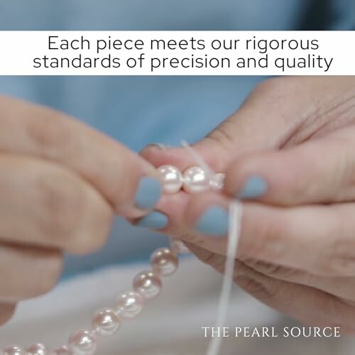 Hands holding and inspecting a string of pearls with a focus on precision and quality.