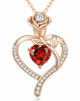 Rose gold heart-shaped pendant with red gem and diamonds.