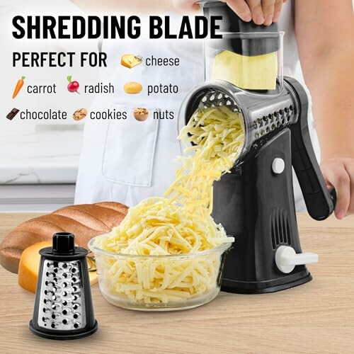 Rotary cheese grater with shredded cheese and interchangeable blades.