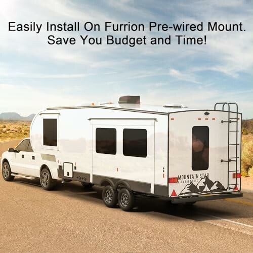 RV trailer towed by a truck on a desert road