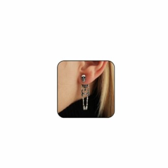 Close-up of a skeleton-shaped earring worn on an ear