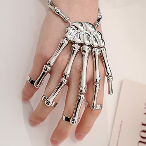 Silver skeleton hand bracelet on a person's hand