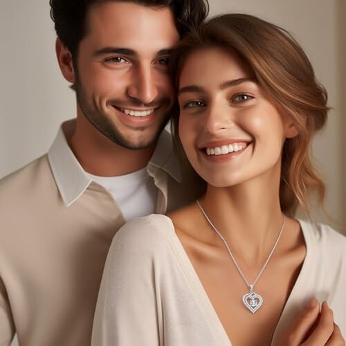 Smiling couple, woman wearing heart-shaped necklace.