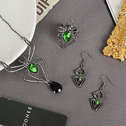 Spider-themed jewelry set with green gemstones, including necklace, earrings, and ring.