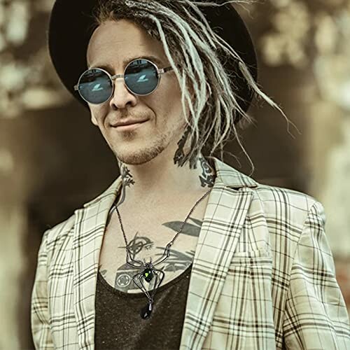 Person with dreadlocks, sunglasses, and plaid jacket.