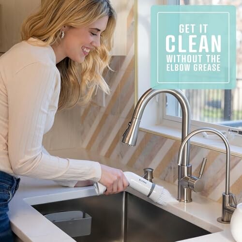 Woman using a cleaning brush on a kitchen sink.
