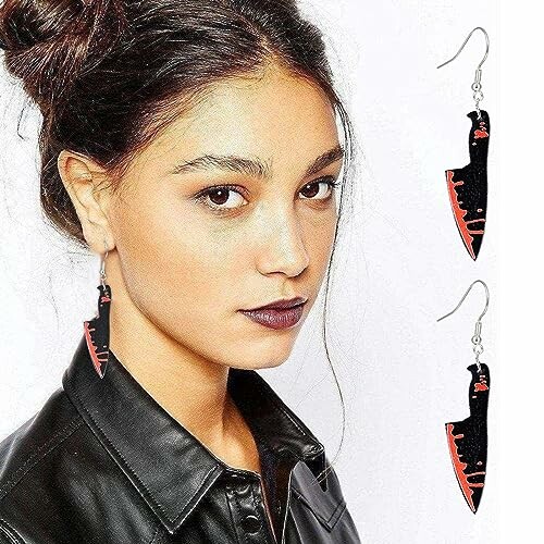 Woman wearing knife-shaped earrings with a leather jacket.