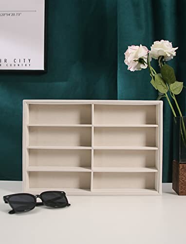 Wooden display shelf with sunglasses and flowers